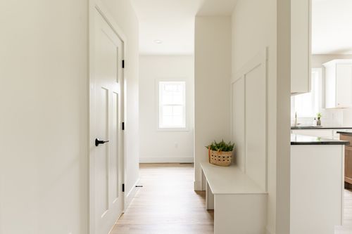 Mudroom hallway with a built-in wood bench nook and a small window
