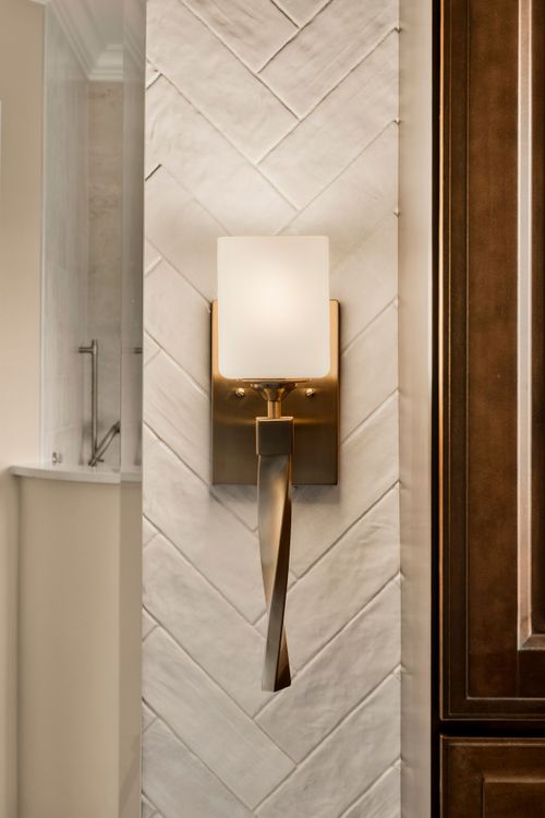 Double vanity bathroom with a dark wood linen tower, mirrors and a mounted television