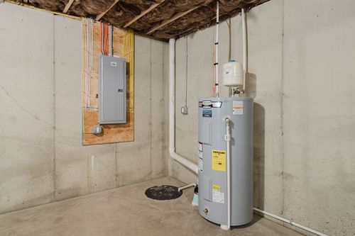 Basement utility area with a water heater and electrical panel