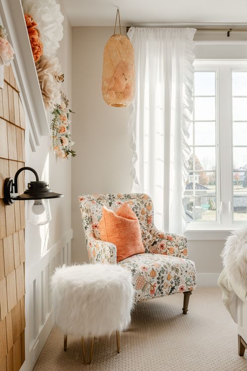 Reading nook with rust velvet swivel chairs, gold side table and sheepskin rug