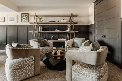 Kids bedroom desk and gray chair set against a peach herringbone accent wall