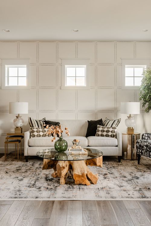 Living room with paneled walls, patterned armchairs and a live-edge wood coffee table