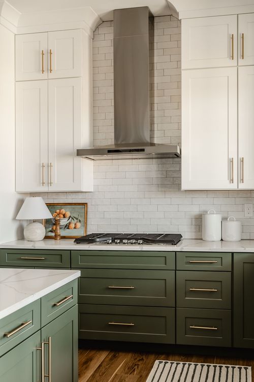 Kitchen counter with stainless range hood, gas cooktop and sage cabinetry