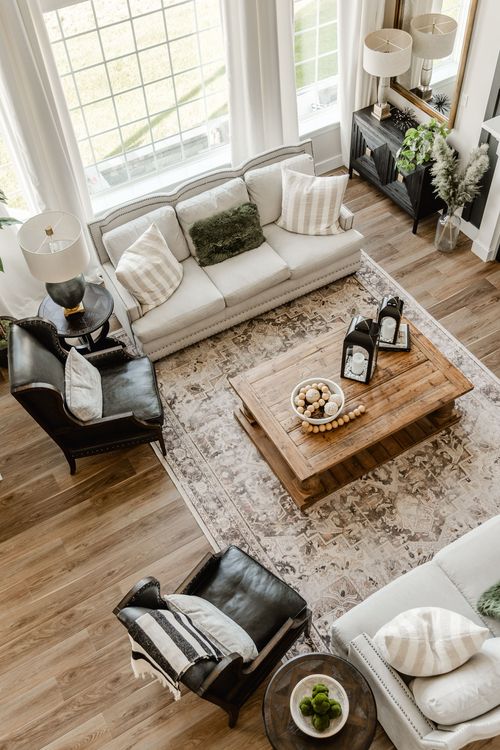 Aerial view of a living room with cream sofa, black leather chairs and patterned rug