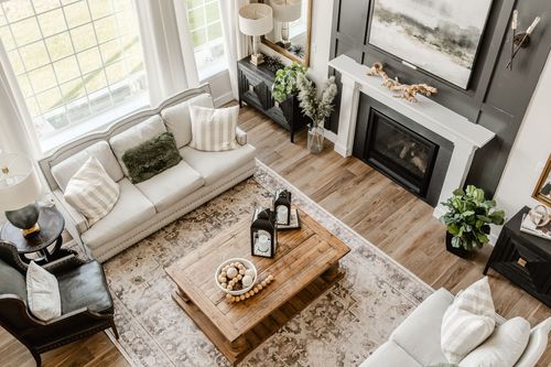 Aerial view of a living room with fireplace, sectional sofa and wood coffee table