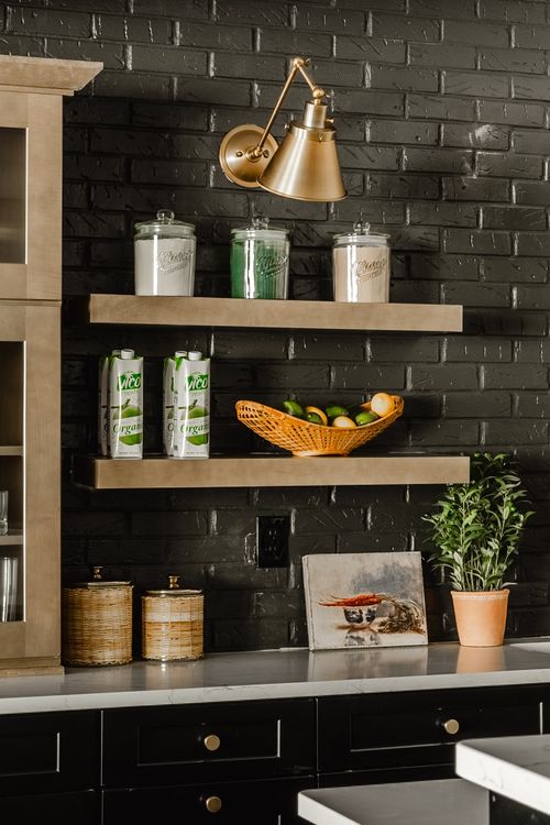 Open shelving detail with glass jars, canned coconut water and a woven fruit basket