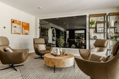 Sitting area with leather swivel chairs around a live-edge round coffee table