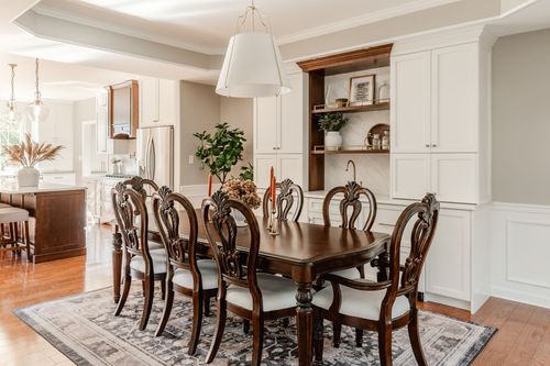 Open dining and kitchen layout with a built-in hutch and a candle-set dining table