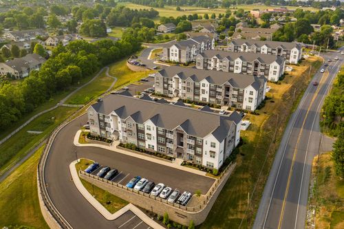 Aerial view of apartment buildings arranged around a curved parking drive