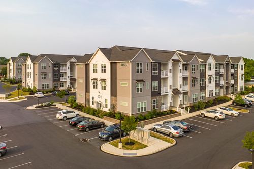 Aerial view of apartment building 400 with covered walkways and a landscaped courtyard entrance