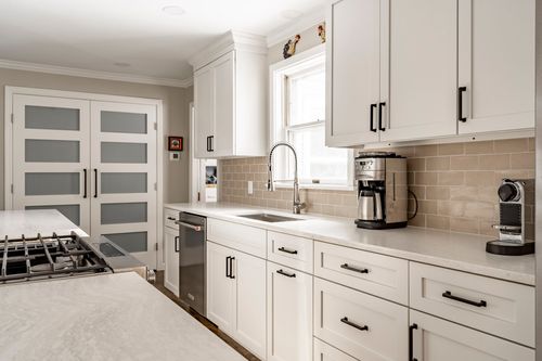 Kitchen sink area with a coffee station and frosted glass French doors