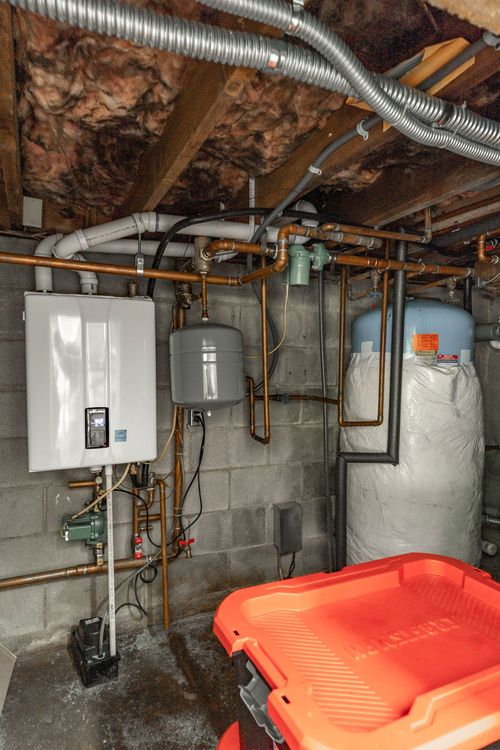Mechanical room with a tankless water heater, expansion tank and copper plumbing