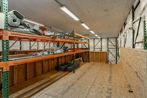 Barn storage room with open shelving units along insulated walls