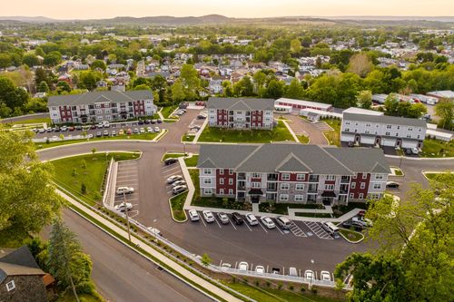 Aerial sunset view of an apartment complex with multiple buildings and parking lots
