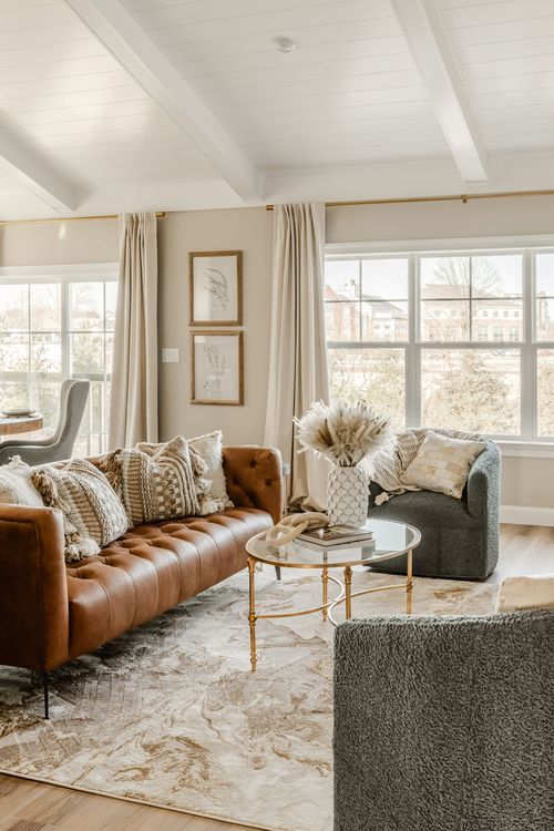 Open-concept living room with fireplace seating opening onto the kitchen beyond
