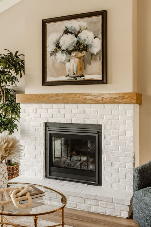 Open-concept living, dining and kitchen space with a chandelier and leather sofa seating
