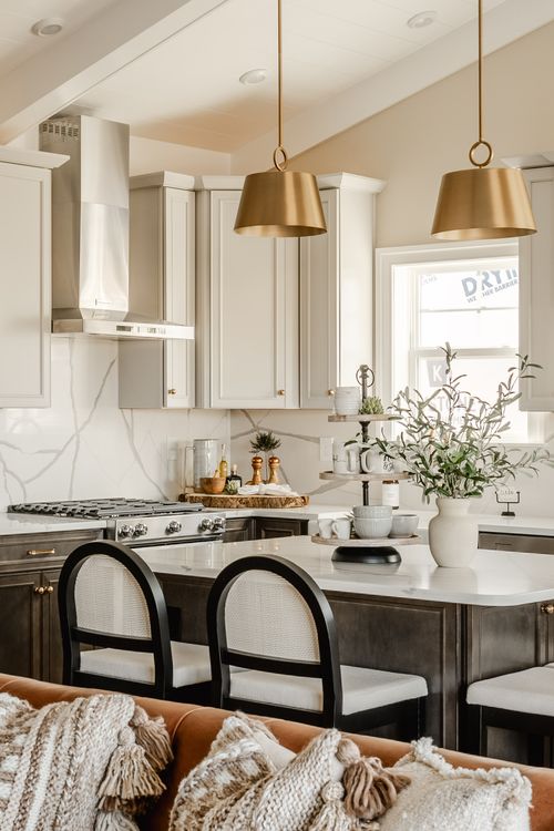 Kitchen detail with glass-front white upper cabinets, dark lower cabinetry and marble backsplash