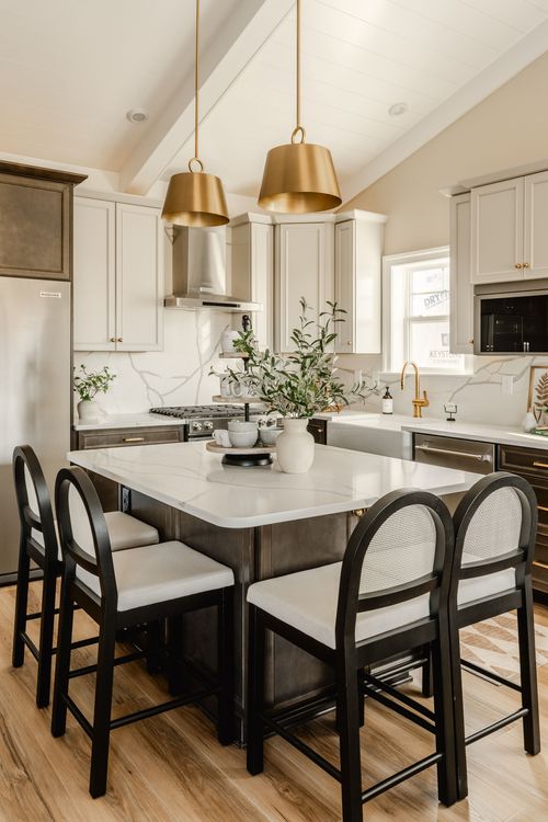 Kitchen with a farmhouse sink, marble backsplash and a diamond-patterned area rug