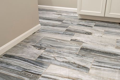 Close-up of gray and white veined plank floor tile