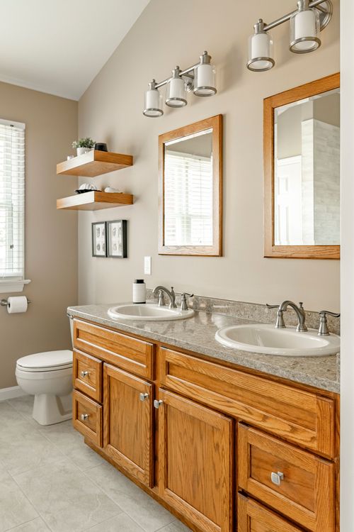 Bathroom with floating wood shelves and an oak double-sink vanity