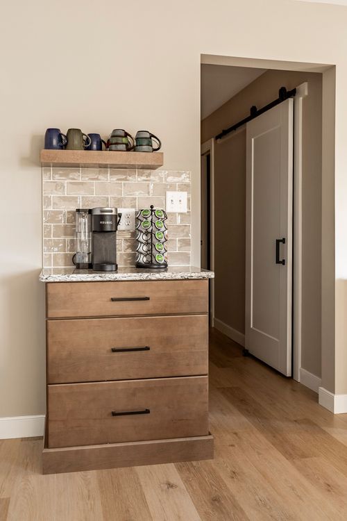 Coffee station with mug shelf, subway tile backsplash and sliding barn door hallway