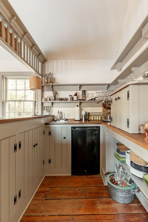 Narrow galley kitchenette with wood countertops and open shelving