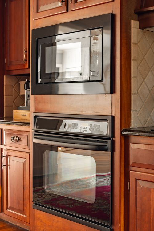 Built-in wall oven and microwave set into wood kitchen cabinetry