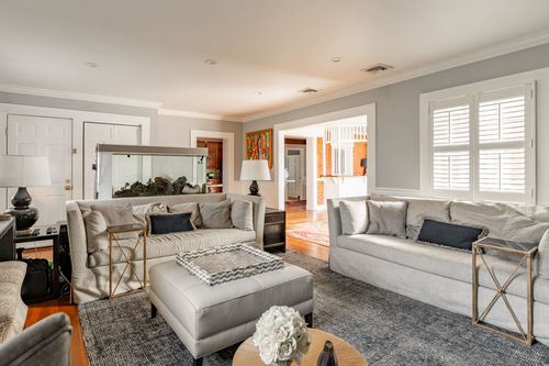 Living room with fish tank, plush sofas and a view through to the dining room