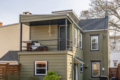 Covered upper balcony with a hanging chair and a view of the rear roofline