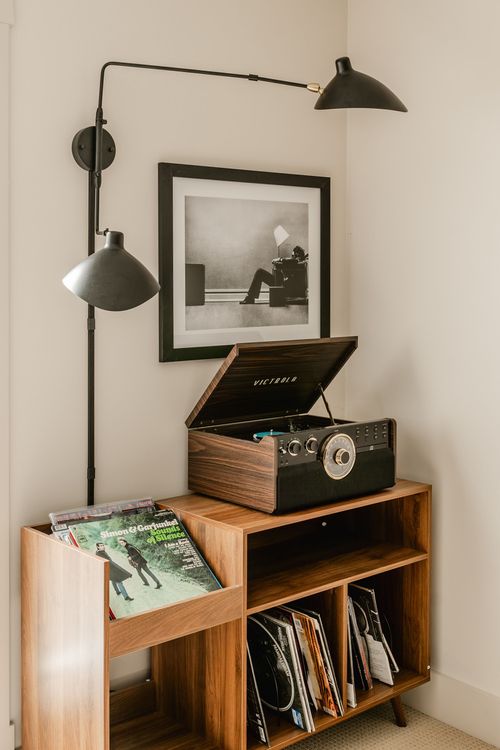 Wood record cabinet with a vintage-style turntable and a framed black-and-white print