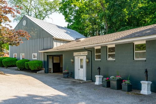 Sycamore Farm barn with metal roof, board-and-batten siding and flanking planters