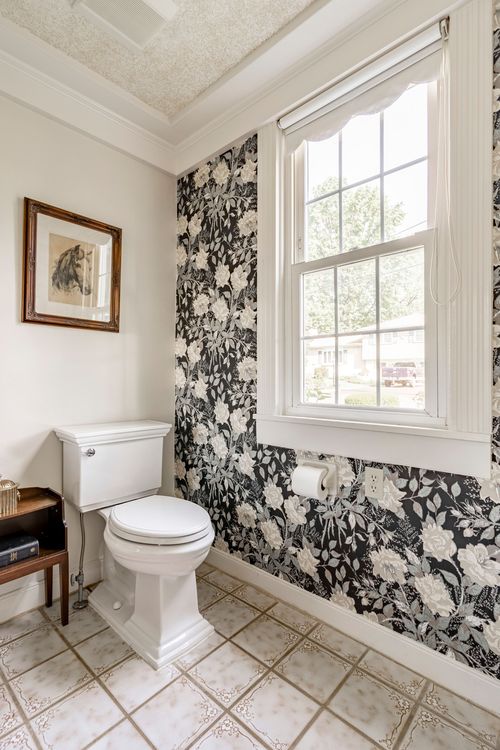 Powder room with bold black and white floral wallpaper and a framed horse print