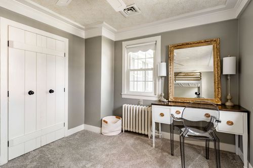 Bedroom with board-and-batten closet doors and an antique-style vanity desk