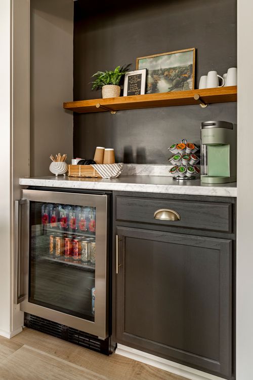Close view of a beverage bar nook with wine fridge, coffee station and open shelf