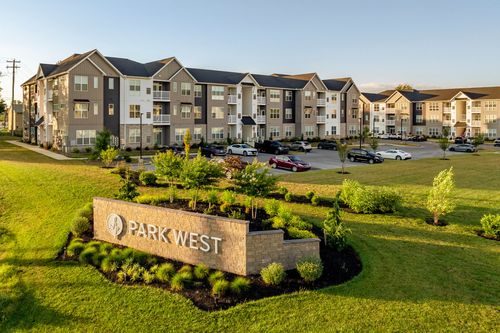 Aerial view of the Park West entry sign with buildings and parking behind