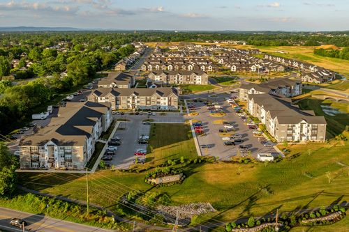Aerial view of the complex with a golf course and distant town in the background