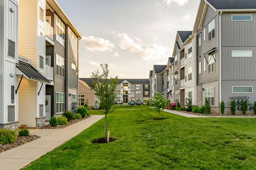 Courtyard between two apartment buildings with a landscaped walking path