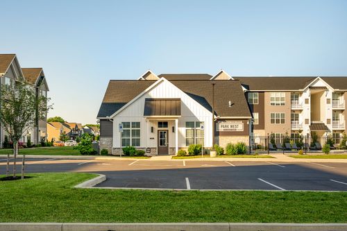 Clubhouse entrance with a gabled roof, stone base and covered porch
