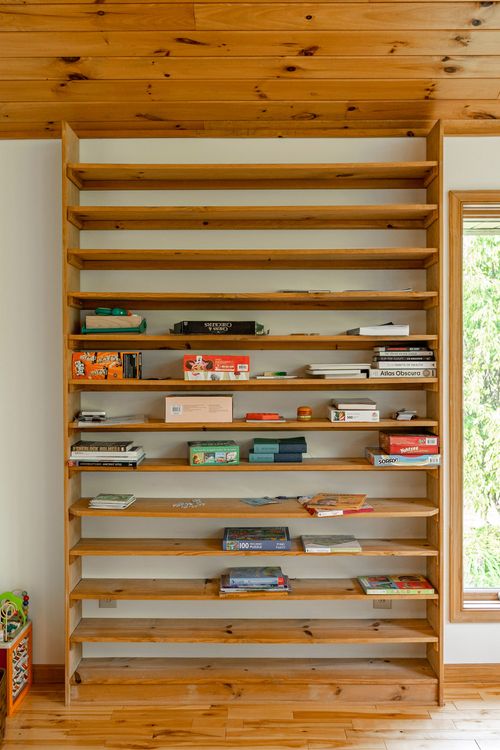 Built-in wood shelving stocked with board games and books