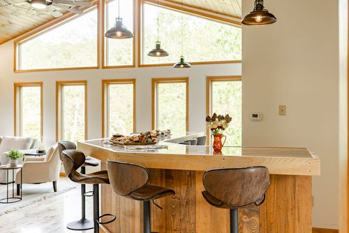 Open kitchen island bar overlooking the living room with a charcuterie board set out