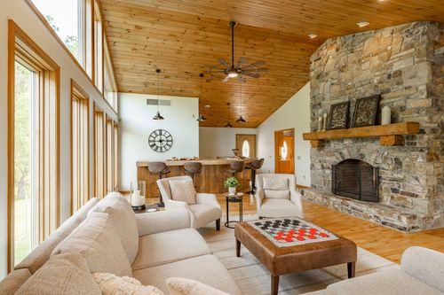 Living room sectional facing a floor-to-ceiling stone fireplace