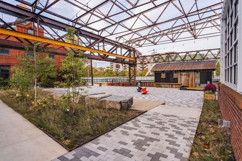 Landscaped courtyard with native grasses, boulders and a wood cabin