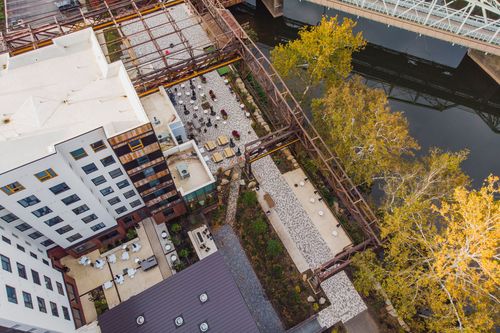 Aerial view of a courtyard hardscape with a geometric paver pattern and steel framework