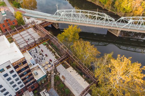 Aerial overview of a courtyard paver patio and steel trestle alongside a hotel building