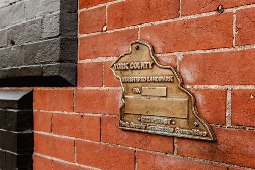Bronze York County registered landmark plaque mounted on a red brick wall
