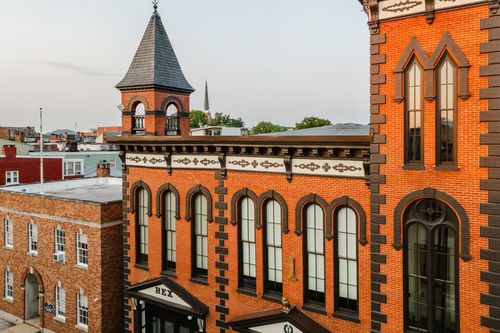 Elevated view of the corner turret and tower rising above the brick building and street