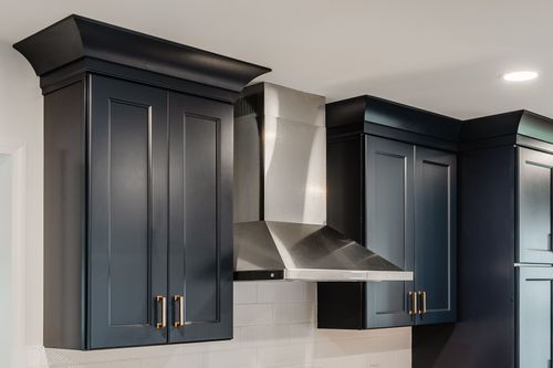 Pull-out kitchen organizer stocked with cooking utensils and bottles