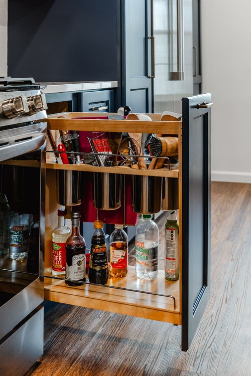 Navy kitchen island with quartz countertop opening onto a dining area