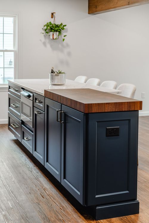 Built-in microwave drawer with a succulent planter on the quartz countertop