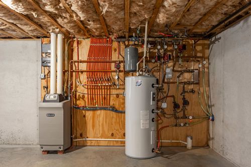 Basement mechanical room with a water heater, furnace and PEX plumbing manifold